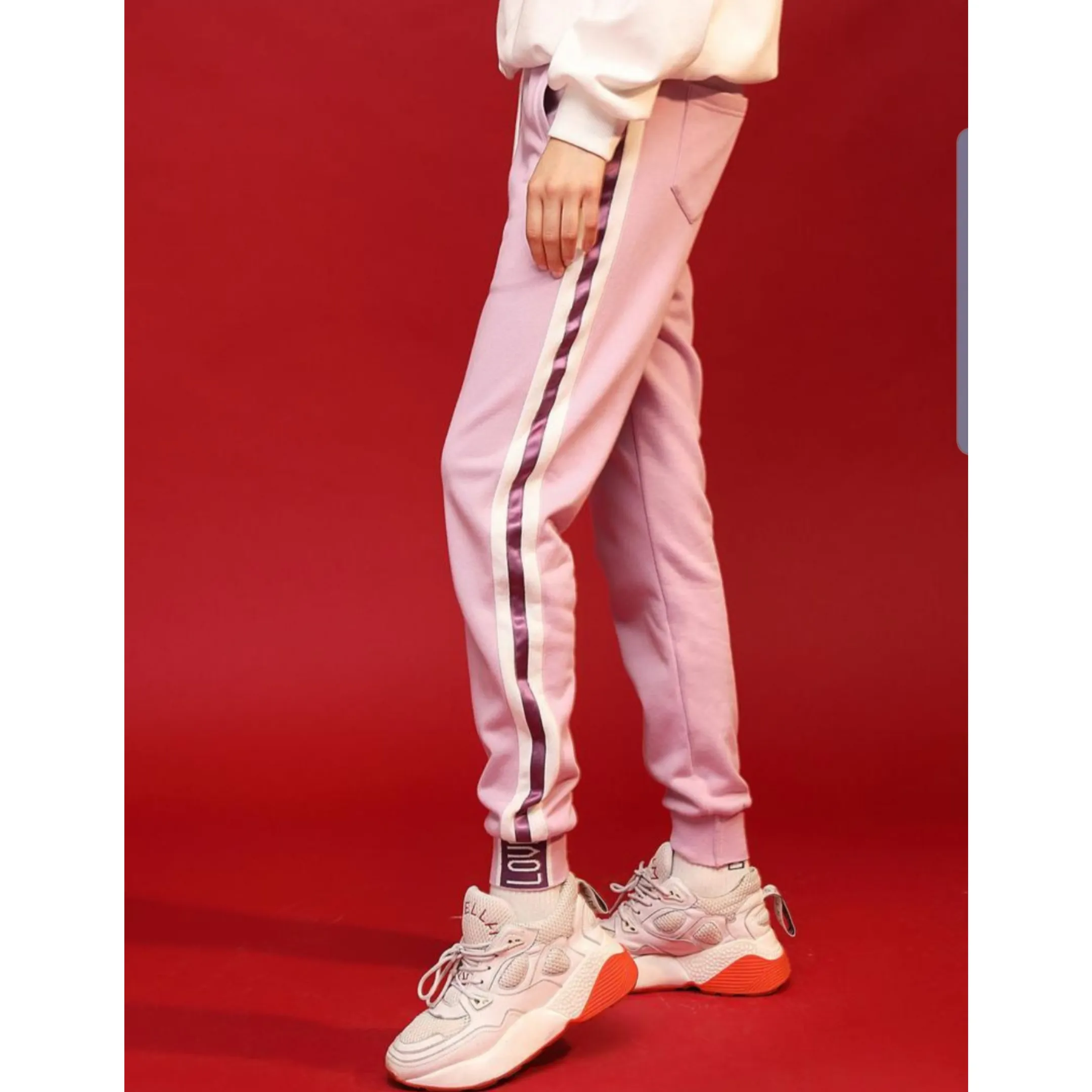 Light purple trackpants with white stripes